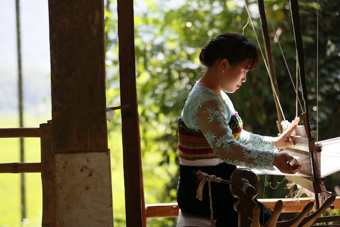 The woven fabric is made by hand with a wooden weaving machine